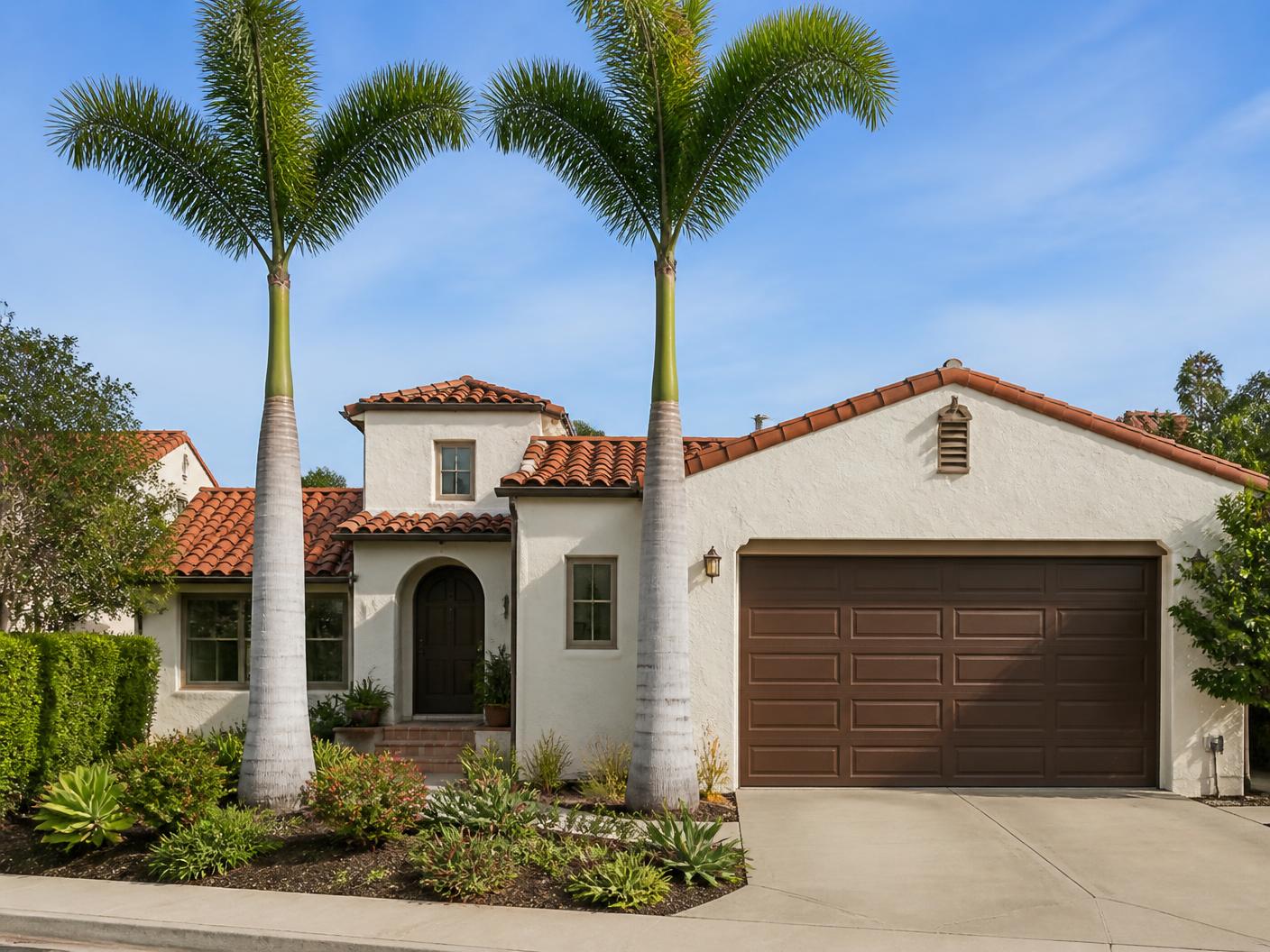 Trimmed palms cleaned up in front of a San Diego home